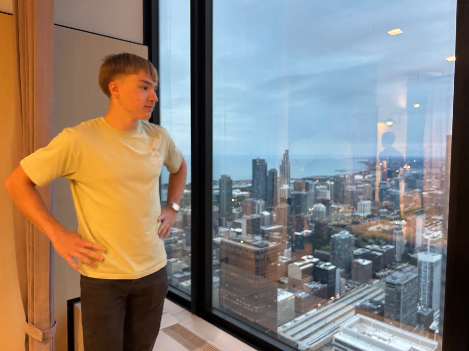 David beside a high-rise window overlooking Chicago