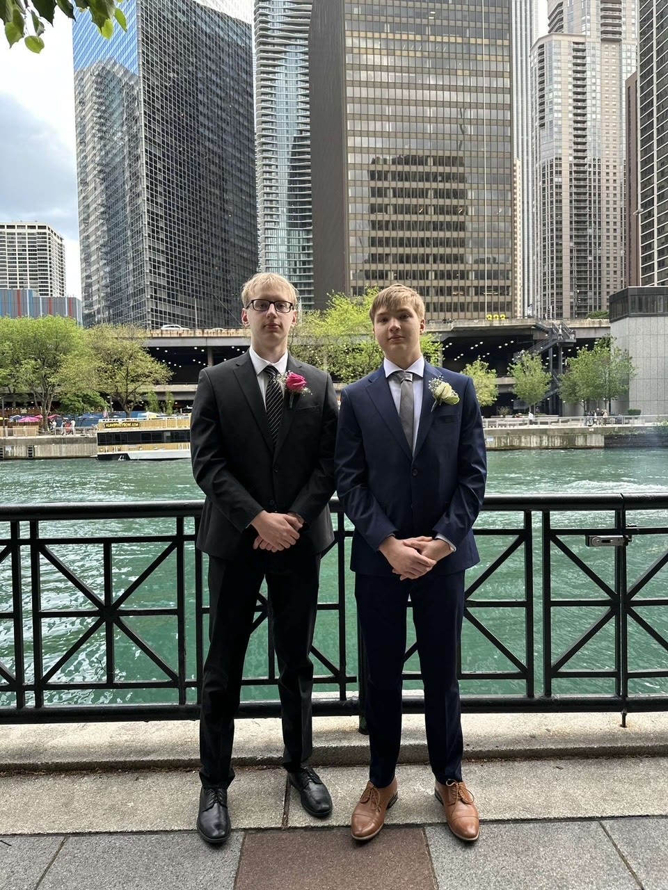 David and a friend dressed formally beside the Chicago River
