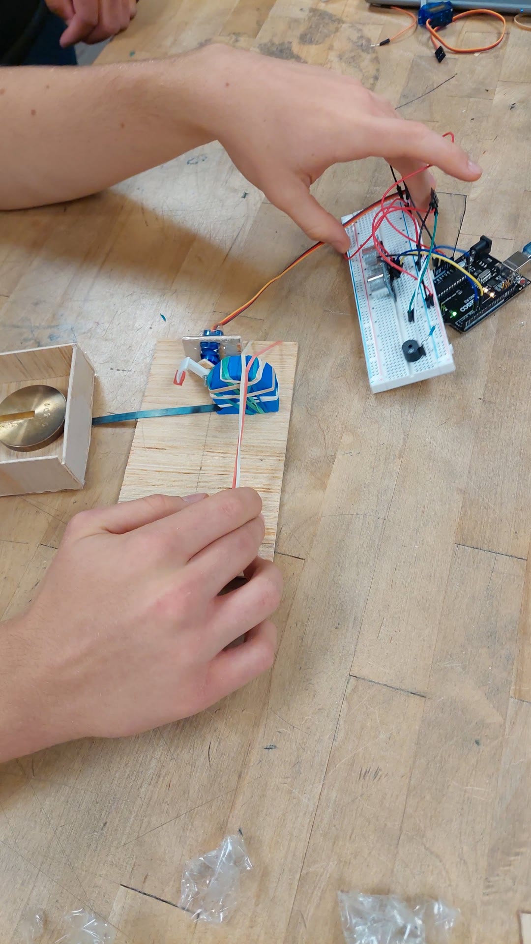 Servo lock and Arduino electronics being integrated with the wooden sled
