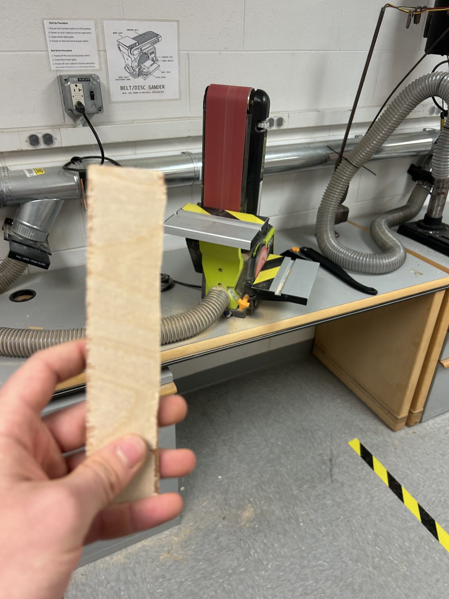 Preparing a wooden strip at a belt and disc sander